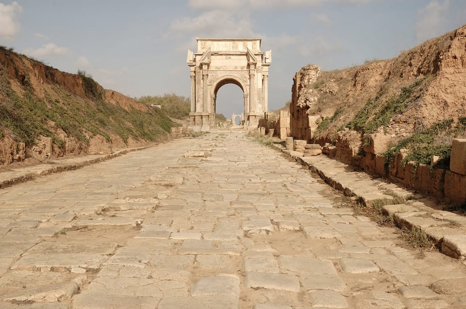 The Roman arch and paved street of Leptis Magna.