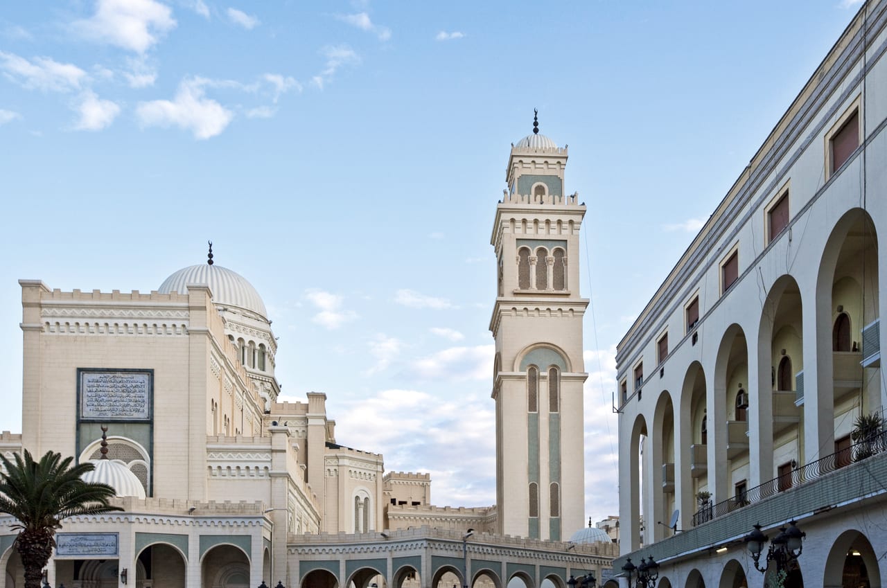 A domed building and a tall tower in the old city of Tripoli, Libya.